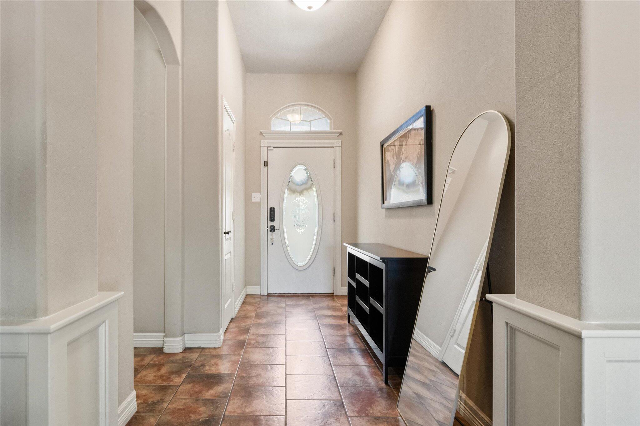 5704 107th Street Lubbock, TX 79424 - Photo 5 of 36 a view of a hallway to a livingroom with furniture