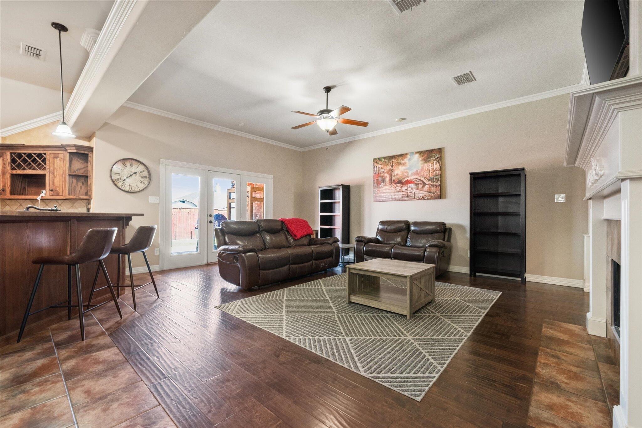 5704 107th Street Lubbock, TX 79424 - Photo 8 of 36 a living room with furniture and view of kitchen