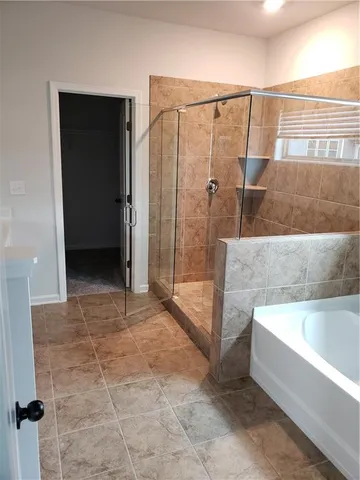 a bathroom with a bathtub and a shower