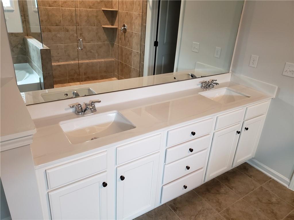 4735 Watkins Way Cumming, GA 30040 - Photo 18 of 31 a bathroom with a double vanity sink and a mirror
