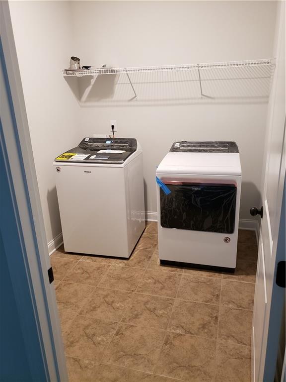 4735 Watkins Way Cumming, GA 30040 - Photo 20 of 31 a utility room with washer and dryer