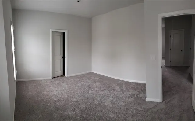 a bathroom with a shower a toilet and a sink