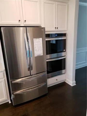 a kitchen with granite countertop a refrigerator and a sink