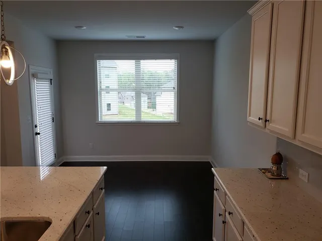 a kitchen with a sink window and cabinets