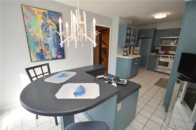 a living room with furniture a flat screen tv and a dining table