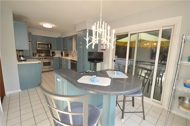 a dining room with furniture a chandelier and wooden floor