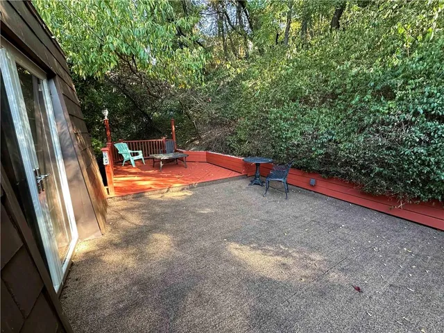 a backyard of a house with table and chairs