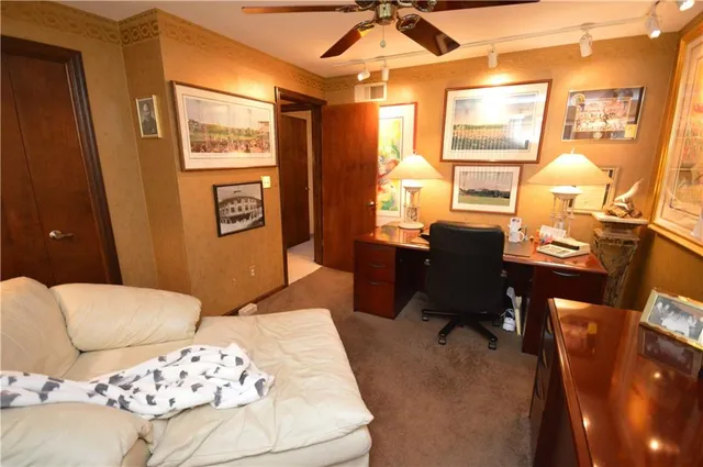 a bathroom with a granite countertop sink a toilet and a shower