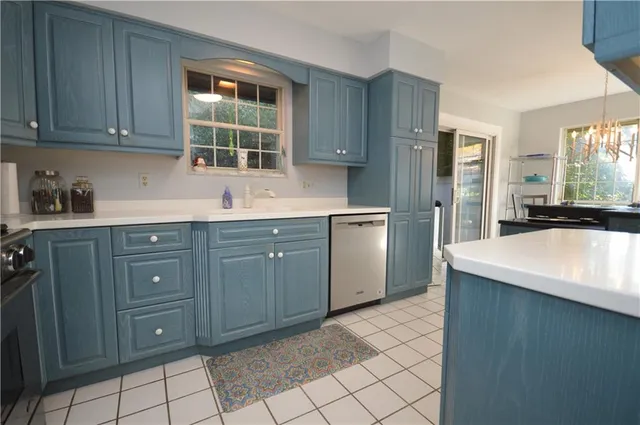 a kitchen with a sink cabinets and window