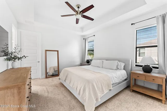 a bedroom with a bed dresser and a window