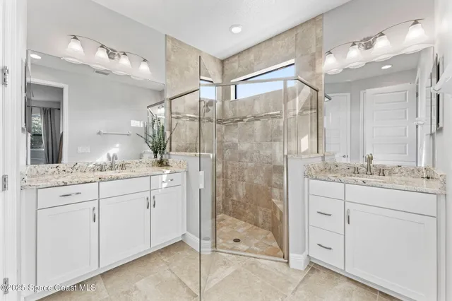 a bathroom with a granite countertop shower sink and mirror