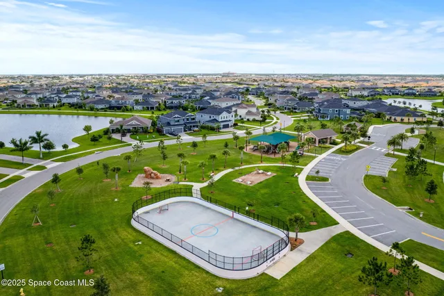 an aerial view of a residential houses with outdoor space and street view