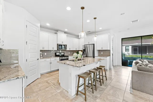 a kitchen with stainless steel appliances kitchen island granite countertop a sink and cabinets