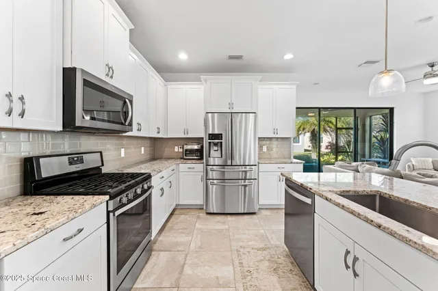 a kitchen with a sink stove and refrigerator