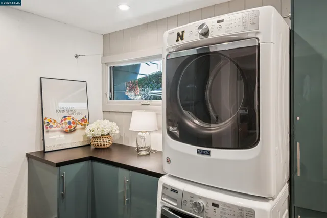 a view of a patio with a table and chairs under an umbrella