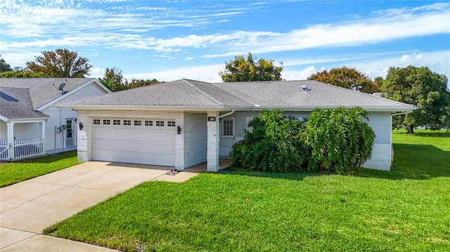 a view of house with garden and a pathway
