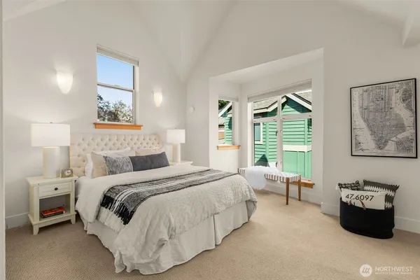 a bedroom with a bed couch and a window