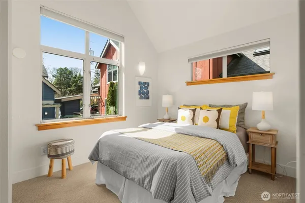 a bedroom with a bed and a large window