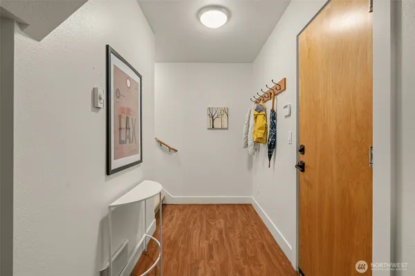 a view of a hallway with wooden floor
