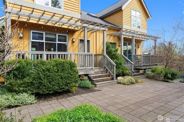 a view of a house with backyard and sitting area