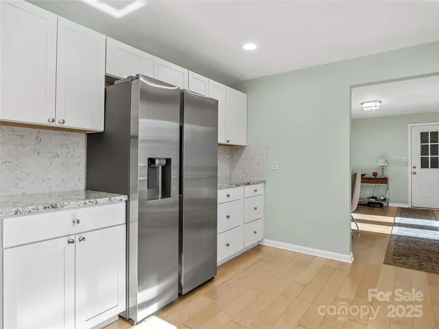 a kitchen with stainless steel appliances granite countertop a refrigerator and a stove