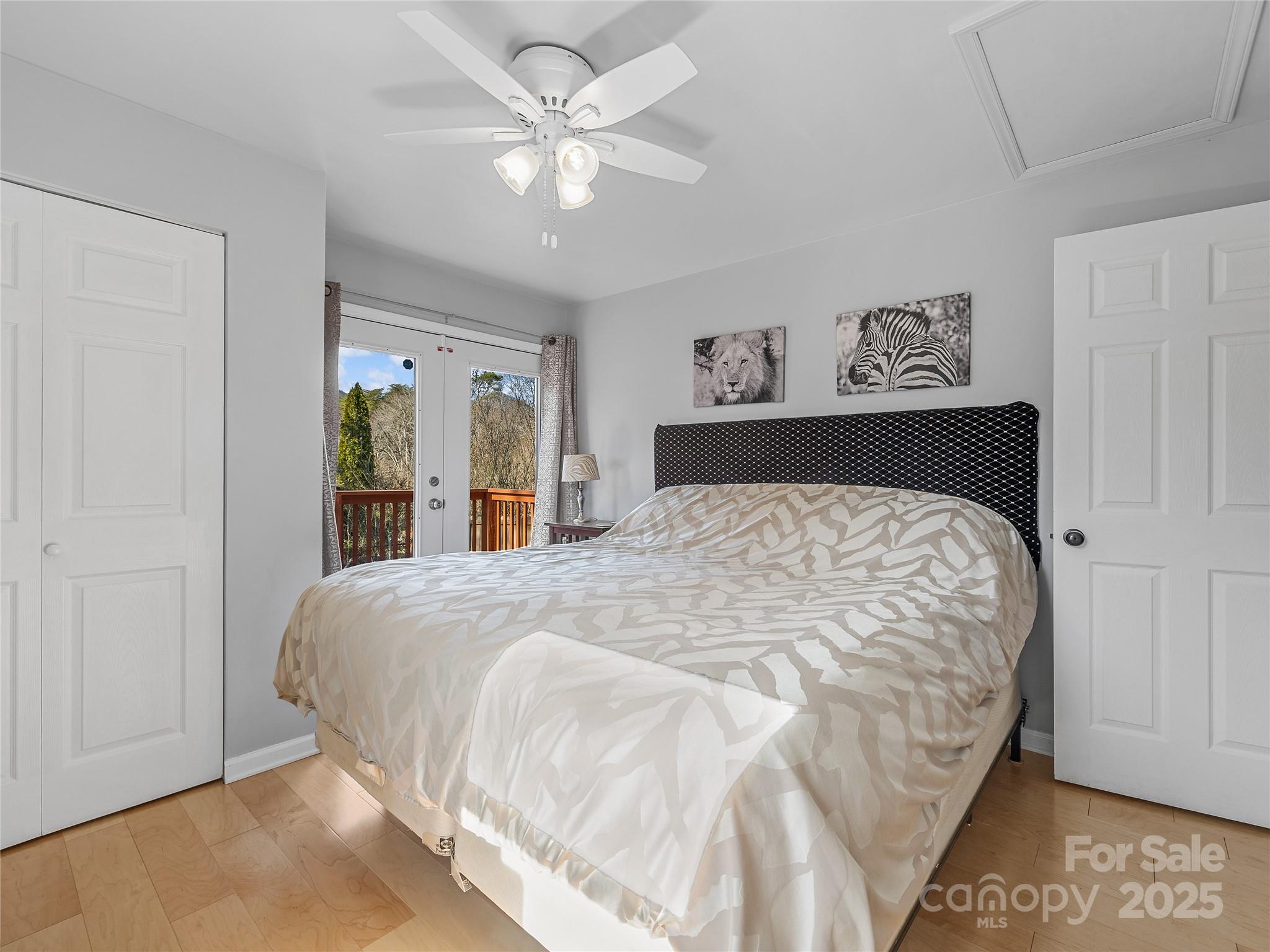 435 Thermal View Drive Tryon, NC 28782 - Photo 16 of 32 a bedroom with a large bed and a chandelier