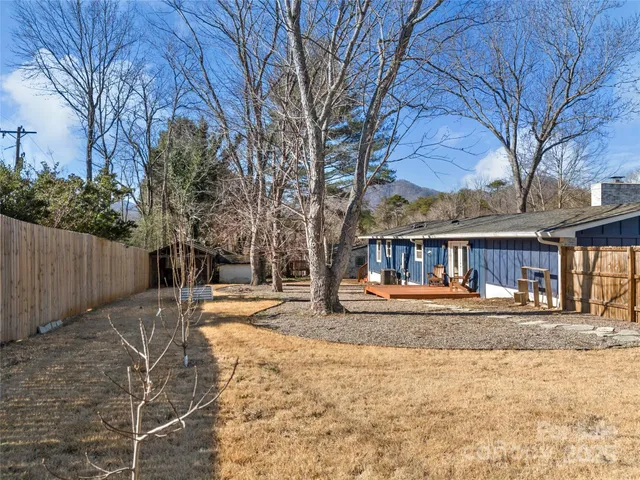 a view of a house with a yard covered with snow