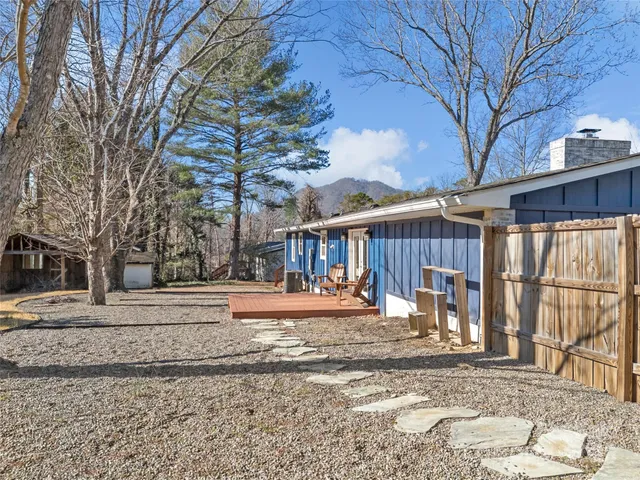 a view of a house with a snow on the side of the road