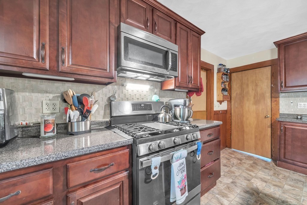 41 Spring Street Warren, MA 01092 - Photo 13 of 42 a kitchen with stainless steel appliances granite countertop a stove a sink and a microwave