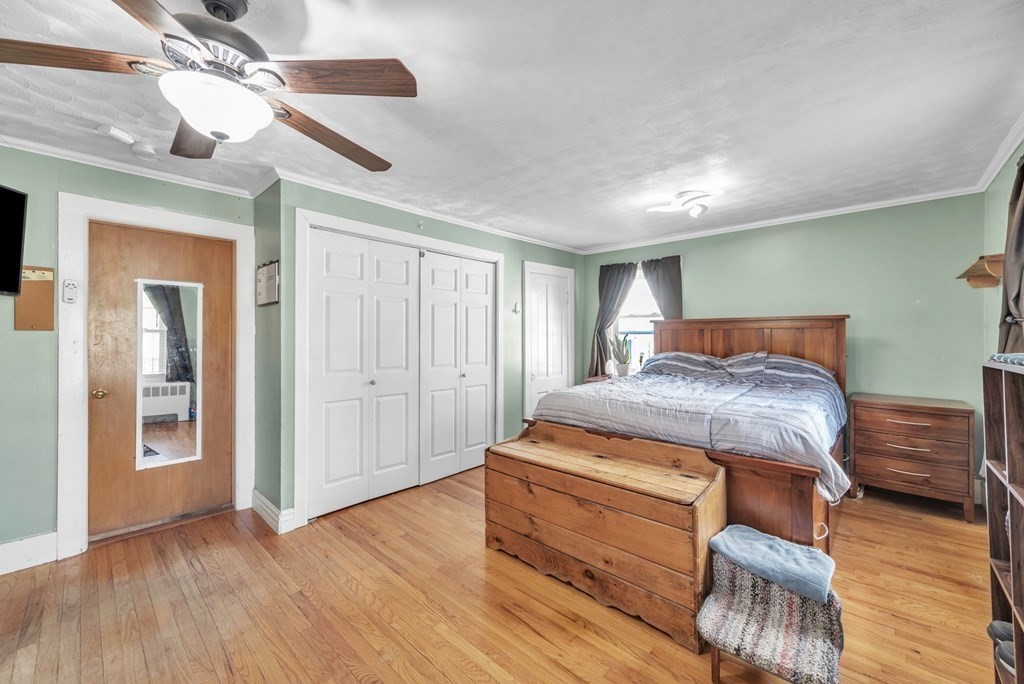 41 Spring Street Warren, MA 01092 - Photo 28 of 42 a bedroom with a bed and wooden floor