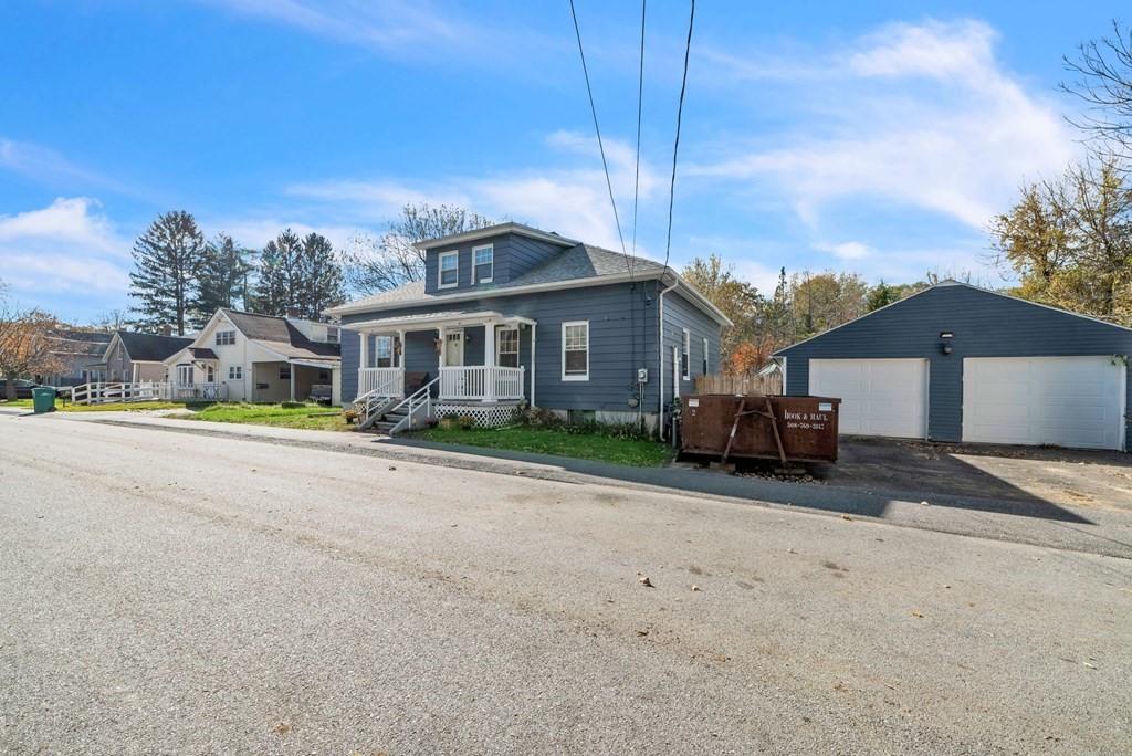 41 Spring Street Warren, MA 01092 - Photo 3 of 42 a front view of a house with a yard and garage