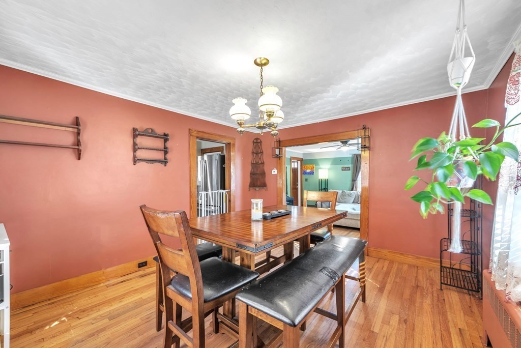 41 Spring Street Warren, MA 01092 - Photo 8 of 42 a dining room with furniture potted plants and wooden floor