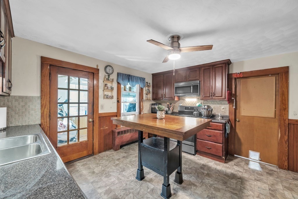41 Spring Street Warren, MA 01092 - Photo 10 of 42 a room with stainless steel appliances kitchen island granite countertop furniture and a window