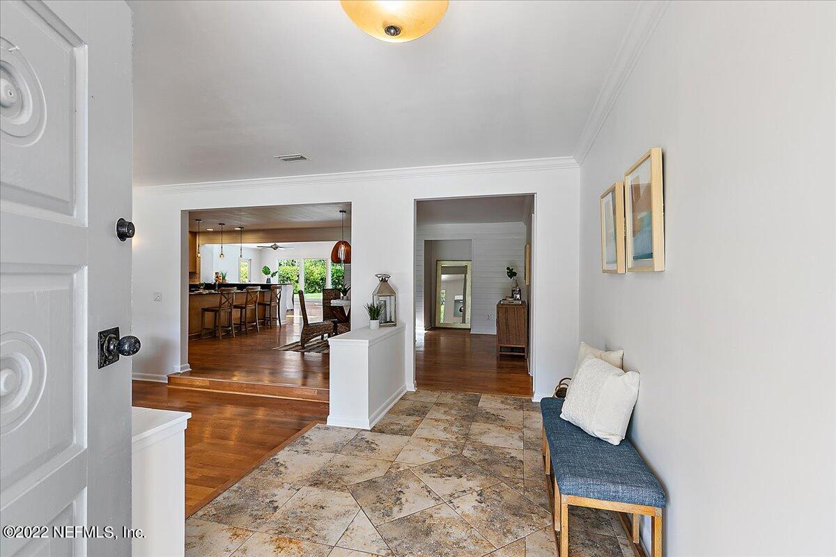 218 Pablo Road Ponte Vedra Beach, FL 32082 - Photo 6 of 42 a view of a hallway with wooden floor and furniture