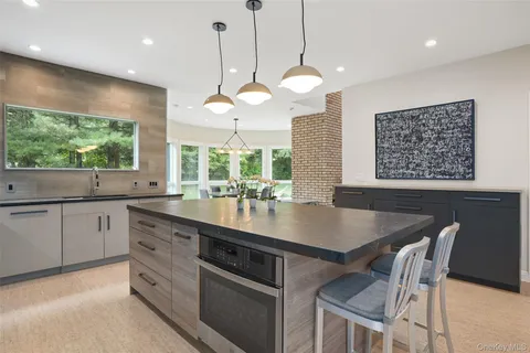 a kitchen with a table chairs and a chandelier