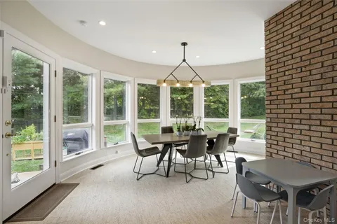 a view of a dining room with furniture window and outside view