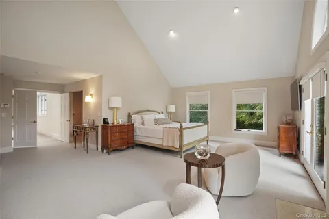 a spacious bedroom with a bed and large windows