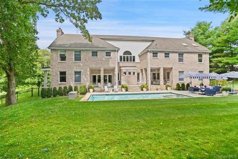 a front view of a residential houses with yard and green space