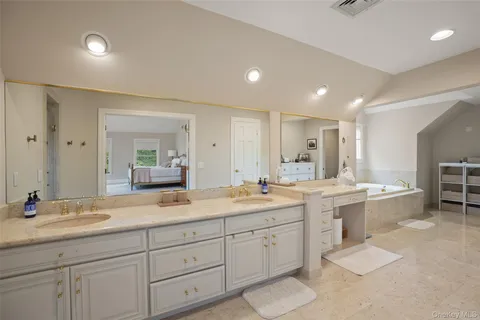 a large bathroom with a large tub and sink