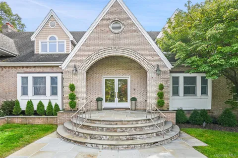 an aerial view of a house with a swimming pool and garden