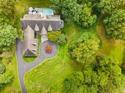 a view of a house with pool and chairs