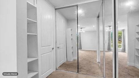 an empty room with windows and closet