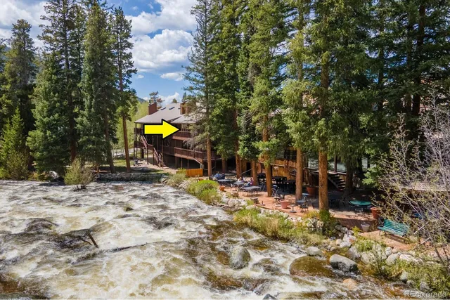 a kitchen with stainless steel appliances granite countertop a stove and a dining table view