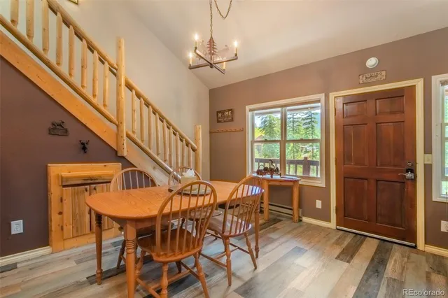 a bedroom with a bed a dresser and a large window