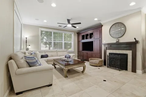 a living room with furniture a large window and a fireplace