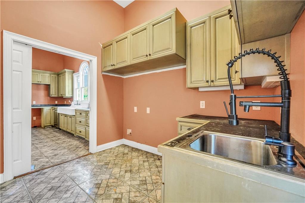 265 Kudzu Road Jenkinsburg, GA 30234 - Photo 20 of 38 a kitchen with a sink and a refrigerator