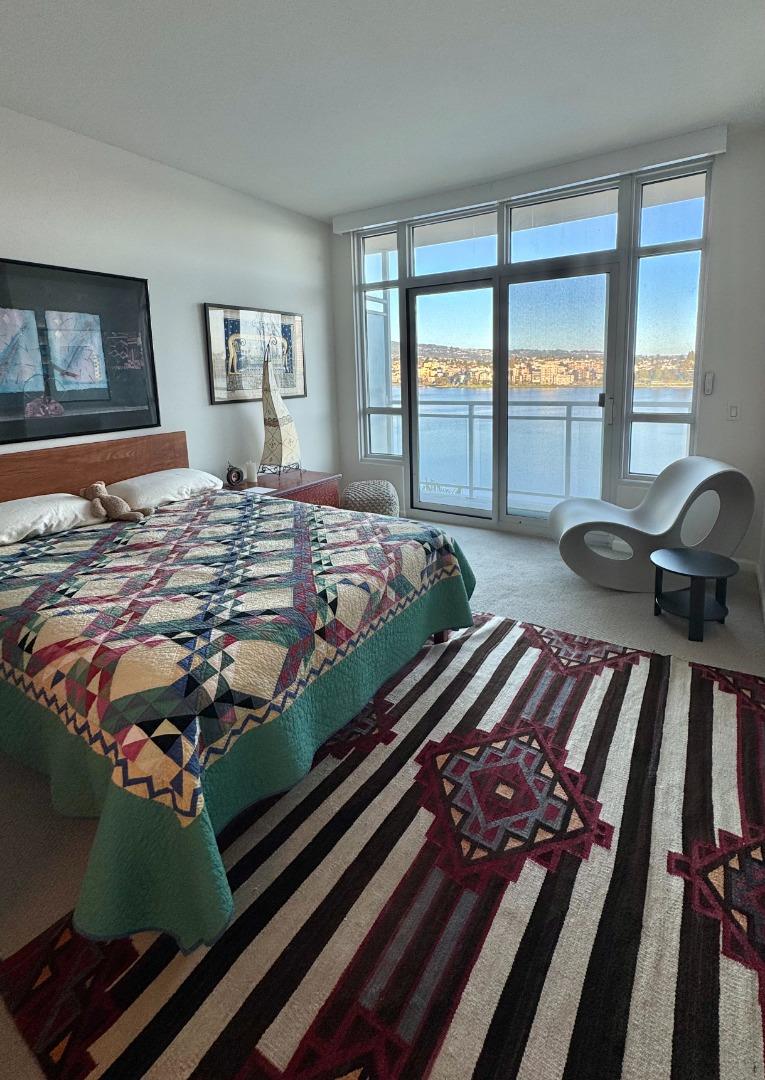 1 Lakeside Drive, Unit 602 Oakland, CA 94612 - Photo 20 of 26 a bed sitting in a bedroom next to a window