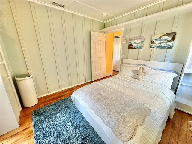 a bedroom with a bed and a mirror