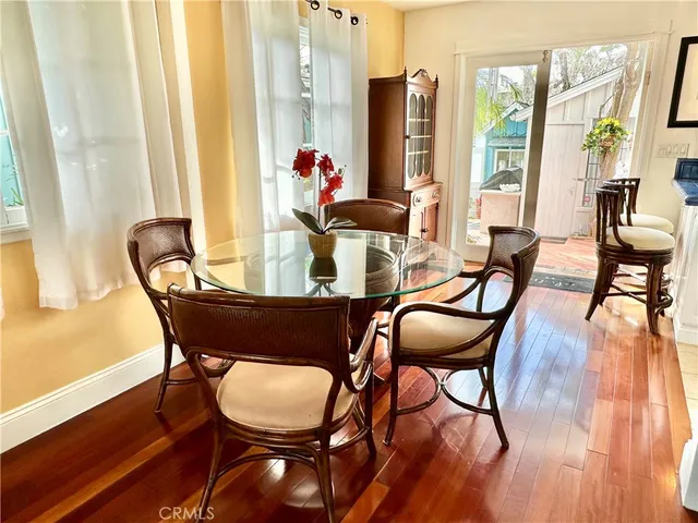 a dining room with furniture and wooden floor