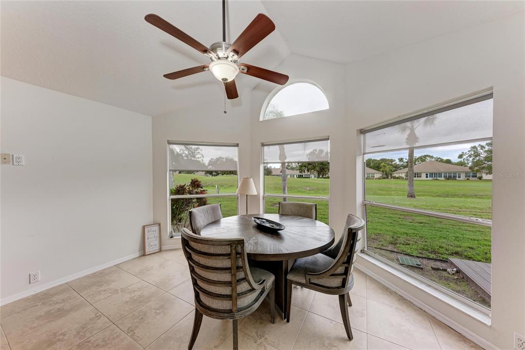 4906 Peridia Boulevard East Bradenton, FL 34203 - Photo 15 of 64 a view of a dining room with furniture window and outside view